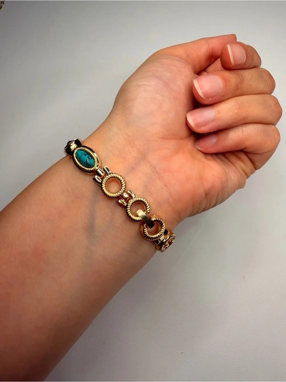 Gold Teardrop Dial Bracelet Watch with Red, Black and Turquoise Accents